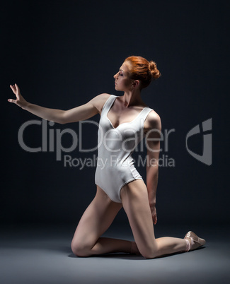 Image of skinny young ballerina posing in studio
