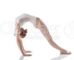 Flexible slim girl doing gymnastic bridge