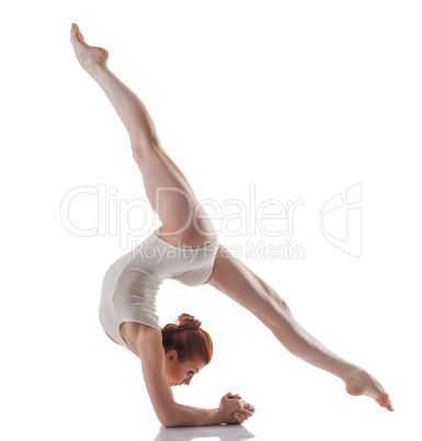 Image of young slender girl doing acrobatic stunt