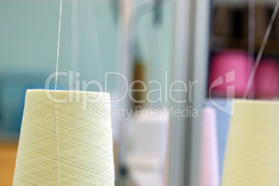 Image of yellow spools and thread background