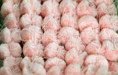 Fluffy pink pompoms for baby clothes