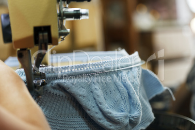 Image of machine knitting blue children's cap