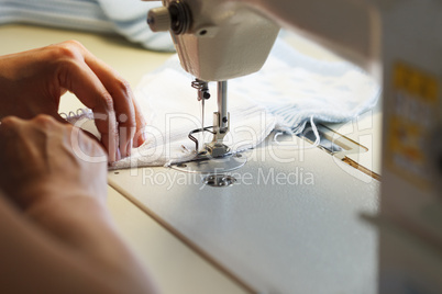 Image of seamstress working on sewing machine