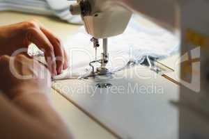Image of seamstress working on sewing machine