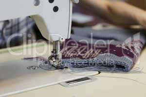 Work in sewing shop at textile factory, close-up