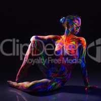 Seductive naked dancer with colorful UV make-up