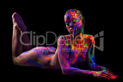 Brightly painted naked model isolated on black