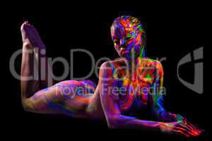 Brightly painted naked model isolated on black