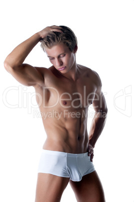 Attractive muscular hunk posing in white briefs