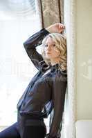 Portrait of pretty blonde in black chiffon blouse