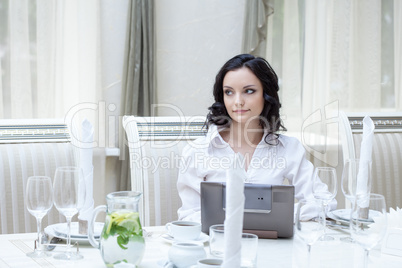 Beautiful girl posing with laptop in restaurant