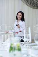 Smiling brunette posing with glass of red wine