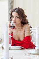 Sexy brunette posing with glass of wine