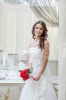 Cheerful beautiful bride posing in restaurant