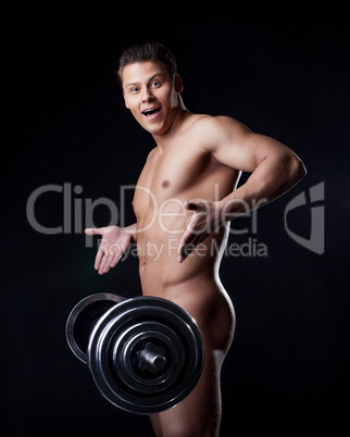 Portrait of astonished naked athlete with barbell