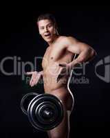 Portrait of astonished naked athlete with barbell