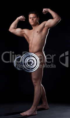 Strong naked man posing lifting barbell