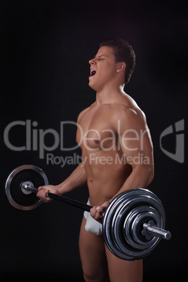Portrait of young athlete lifting weights