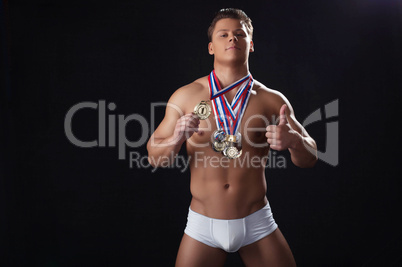 Attractive strong champion posing with awards