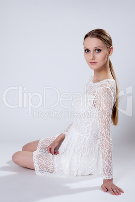 Romantic young girl posing in elegant dress