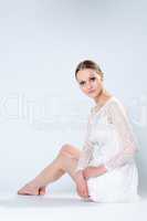 Charming woman posing in white dress