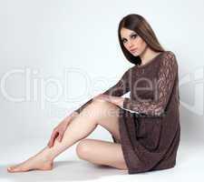 Sensual brunette posing in brown lace gown
