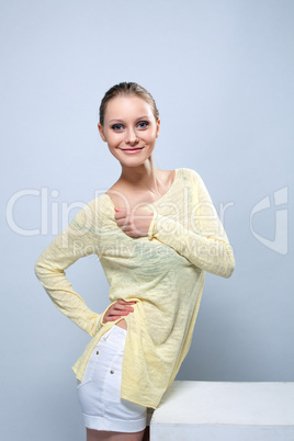 Smiling cute girl posing in yellow blouse