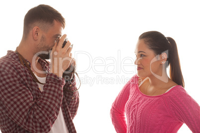 young man photographing young woman