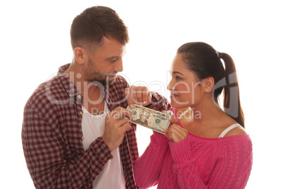 young couple holding a twenty us dollar bank note