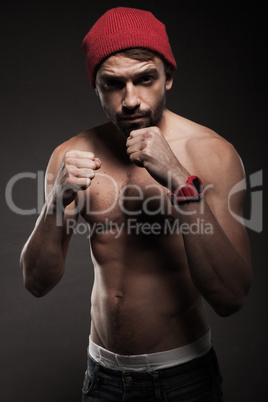 portrait of a fit young man in an aggressive pose