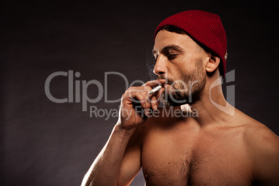 bare chested man smoking