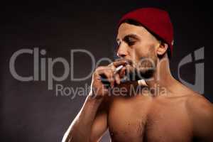 bare chested man smoking
