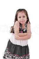 angry little girl in dress with arms crossed on white background