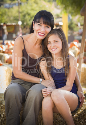 attractive mother and daughter portrait at the pumpkin patch.