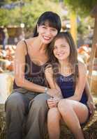 attractive mother and daughter portrait at the pumpkin patch.