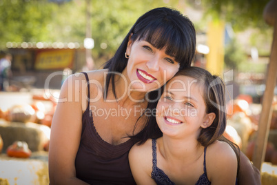 attractive mother and daughter portrait at the pumpkin patch.