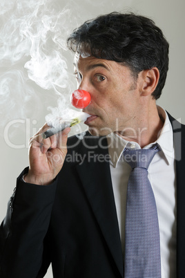 man in a red nose puffing on an e-cigarette