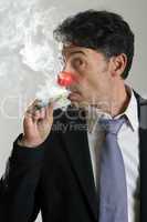 man in a red nose puffing on an e-cigarette