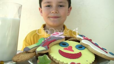 child eating yummy cookies and drinking milk