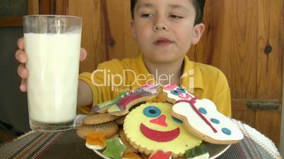 child eating yummy cookies and drinking milk