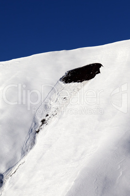 trace of avalanche on off piste slope in sun day. close-up view.