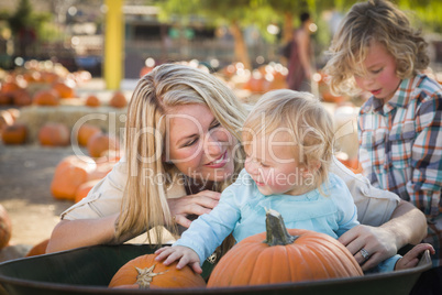 young family enjoys a day at the pumpkin patch