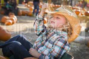 little boy in cowboy hat at pumpkin patch