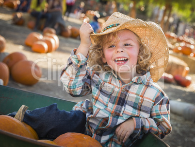 little boy in cowboy hat at pumpkin patch