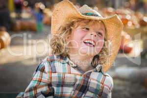 little boy in cowboy hat at pumpkin patch