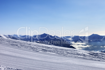 ski slope and snowy mountain in haze
