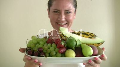 Woman holding plate with fruit