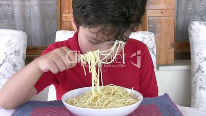 young boy eating spaghetti