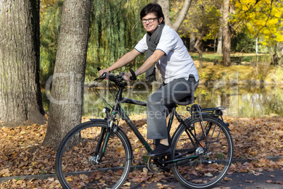 woman on bicycle in autumn park