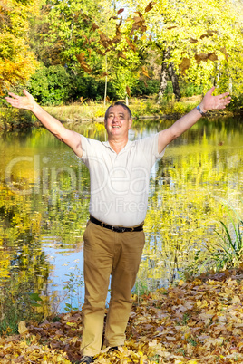 man stands on the lake and having fun at the autumn